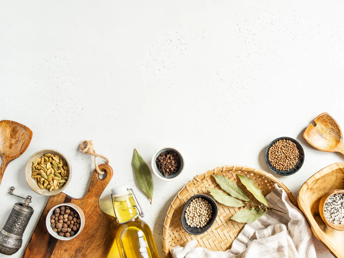 Bowls of spices and olive oil on a light table